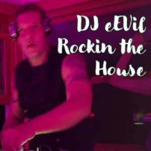 An fair skinned man wearing earphones, at his decks "Rockin the House"