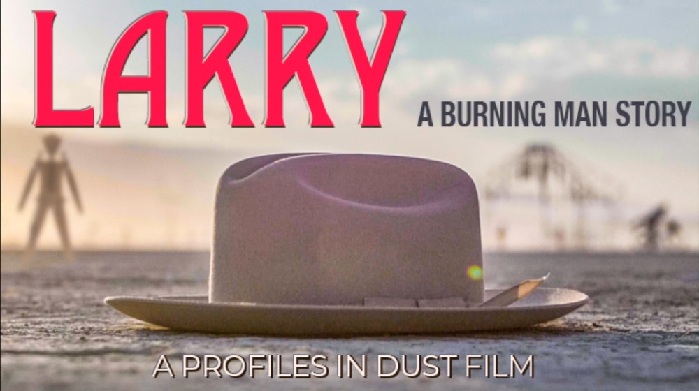 Movie poster of close-up of a fedora hat on the Burning Man playa with the silhouette of the man in the background. 